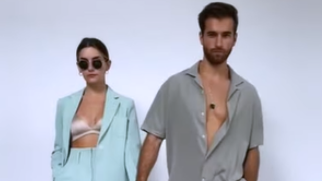 A stylish husband and wife pose together in relaxed, modern tailored clothing, showcasing trendy dinner date night outfits and casual dinner date outfit ideas for married couples.